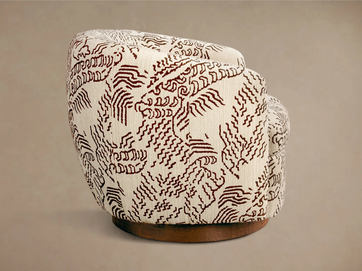 Rear view of the Cream Cerrito Swivel Chair, upholstered in fabric with a brown abstract wavy pattern, on a dark brown wooden swivel base.