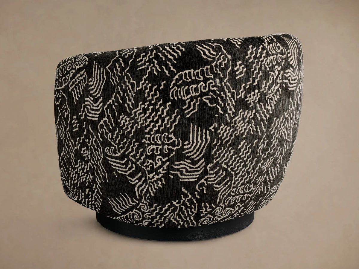 Side view of the black Cerrito Swivel Chair featuring a white abstract wavy line pattern and a black swivel base.