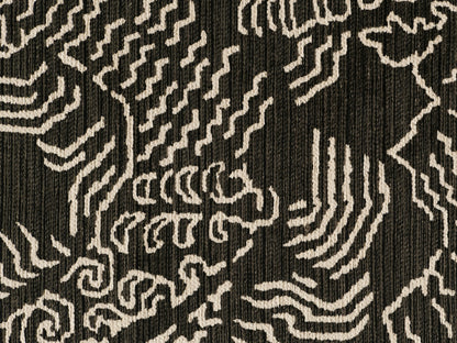 Close-up of the dark charcoal textured woven fabric with a cream abstract pattern for the Cerrito Swivel Chair.