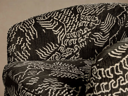 Close-up of the dark charcoal upholstery with an off-white abstract wave pattern on the Cerrito Swivel Chair.