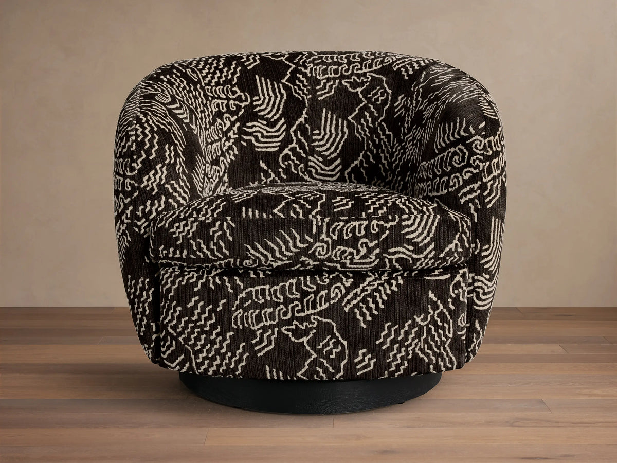 Front view of the dark brown Cerrito Swivel Chair with a white abstract pattern, featuring a black round swivel base.