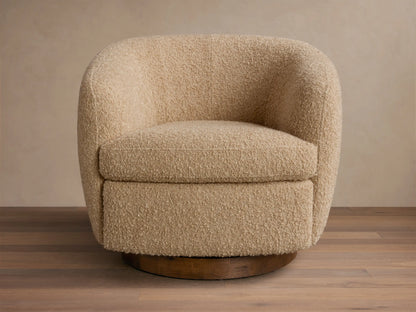 Front view of the light beige boucle Cerrito Swivel Chair with a rounded design and a dark wood swivel base.