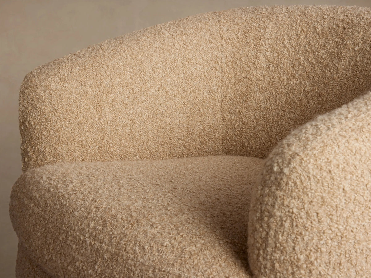 Front view of the beige boucle Cerrito Swivel Chair with a rounded back, deep seat, and a dark wood swivel base.