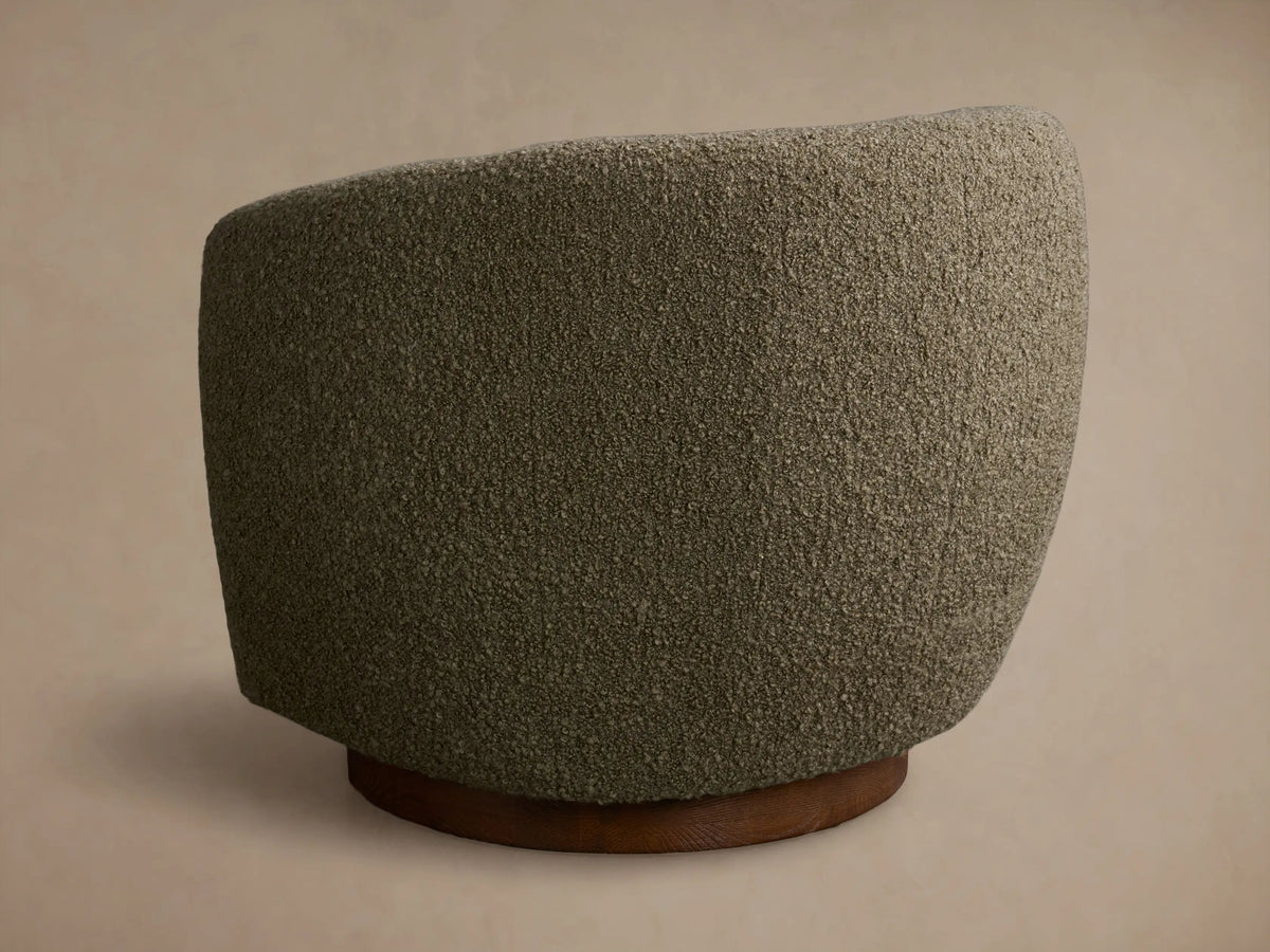 Close-up of the moss green textured upholstery fabric of the Cerrito Swivel Chair, showing its soft, looped surface.