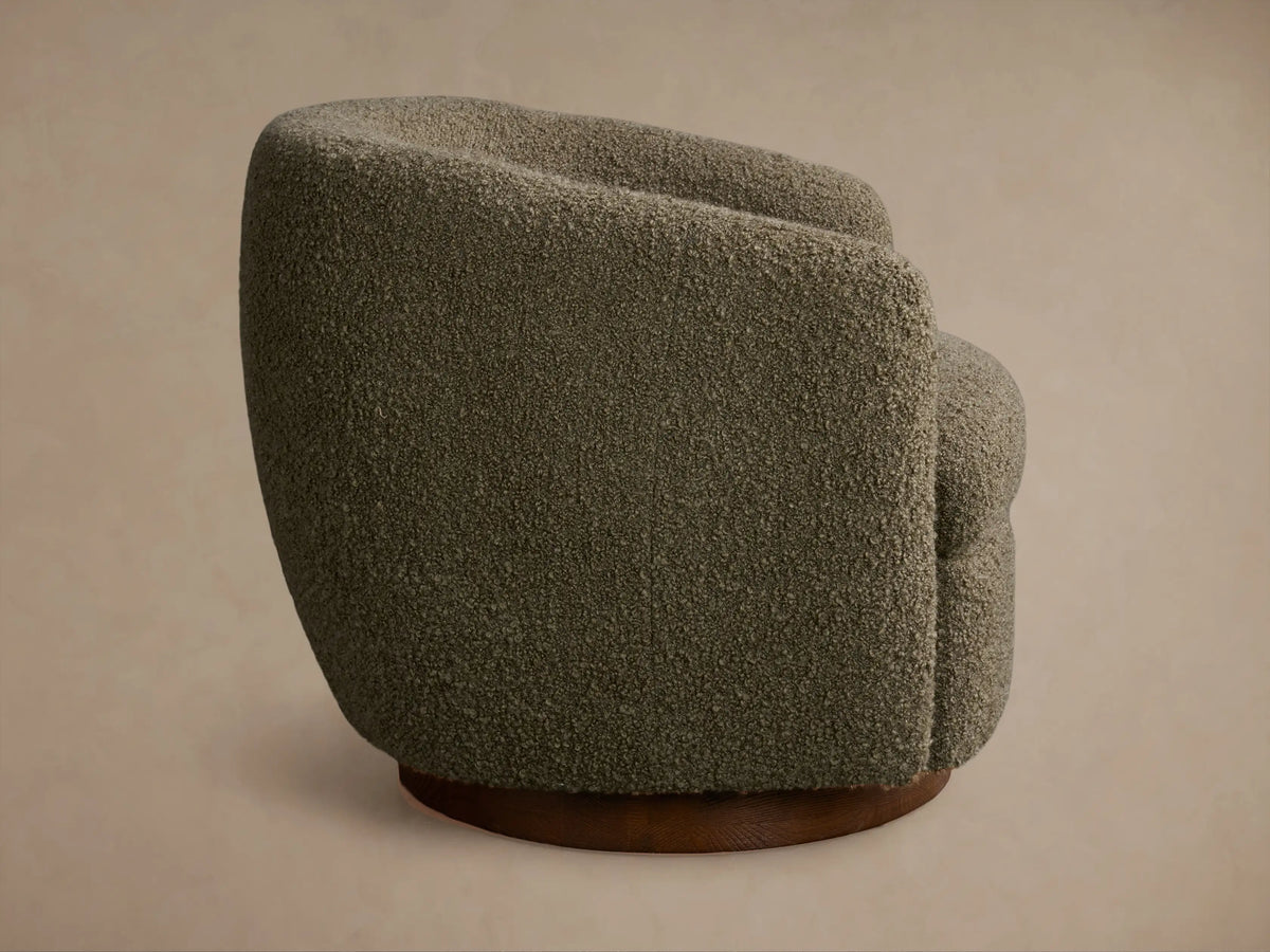 Rear view of the olive green textured Cerrito Swivel Chair with a round wooden swivel base.