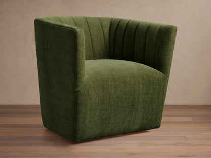 Green Griffin Swivel Chair with a rounded back and vertical channel tufting, set on a wooden floor.