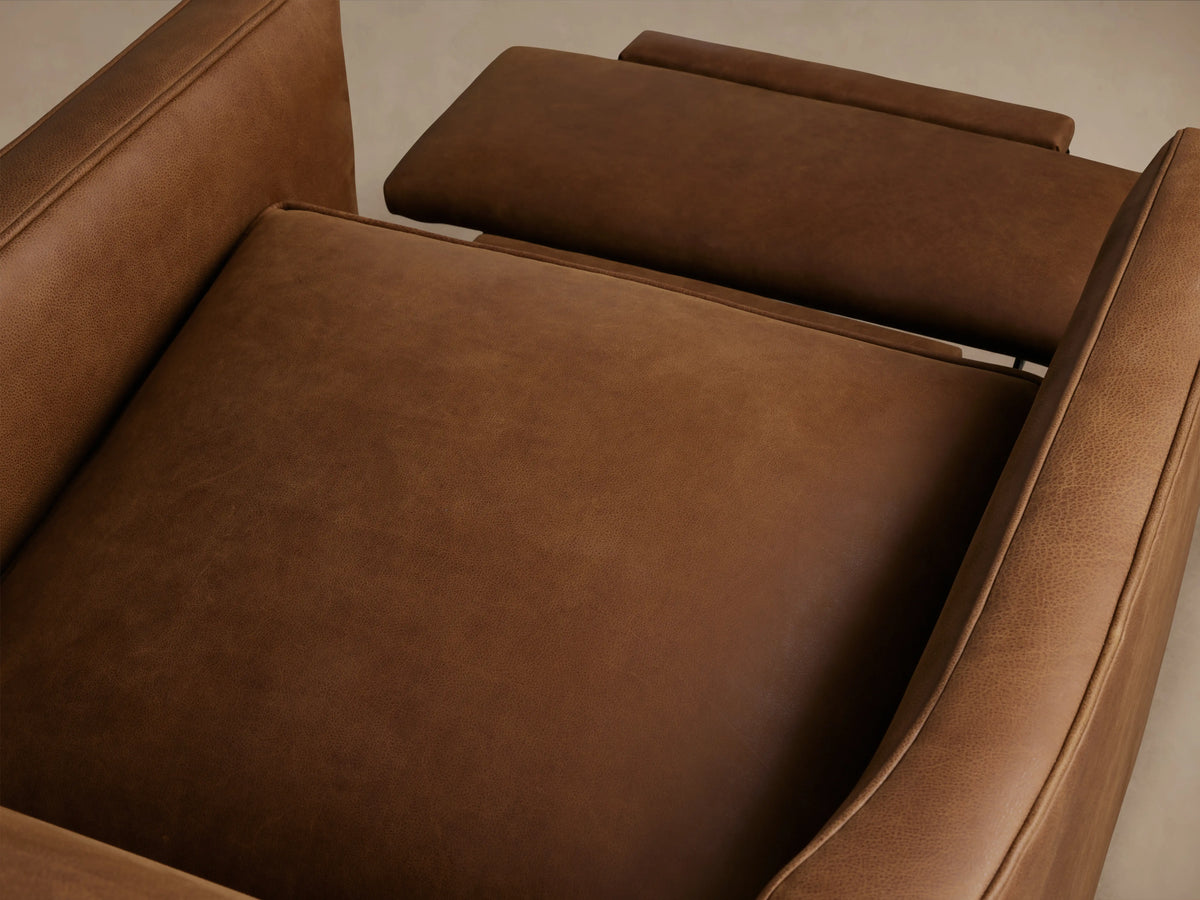 Rudy Leather Swivel Recliner in rich brown leather, features straight arms, plush seat cushion, and sleek design on wooden floor.