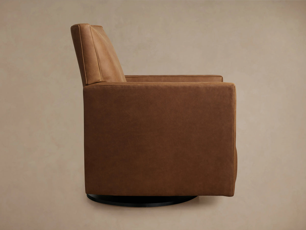 Rudy Leather Swivel Recliner in rich brown leather, top view showing seat, armrests, and extended footrest on a beige floor.