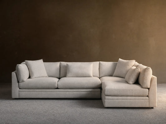Front view of the light gray Pavo Two-Piece Sectional, an L-shaped sofa with plush seat and back cushions.
