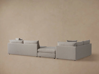 Front view of the light gray Pavo Three-Piece Sectional, arranged in an L-shape with plush seat and back cushions.