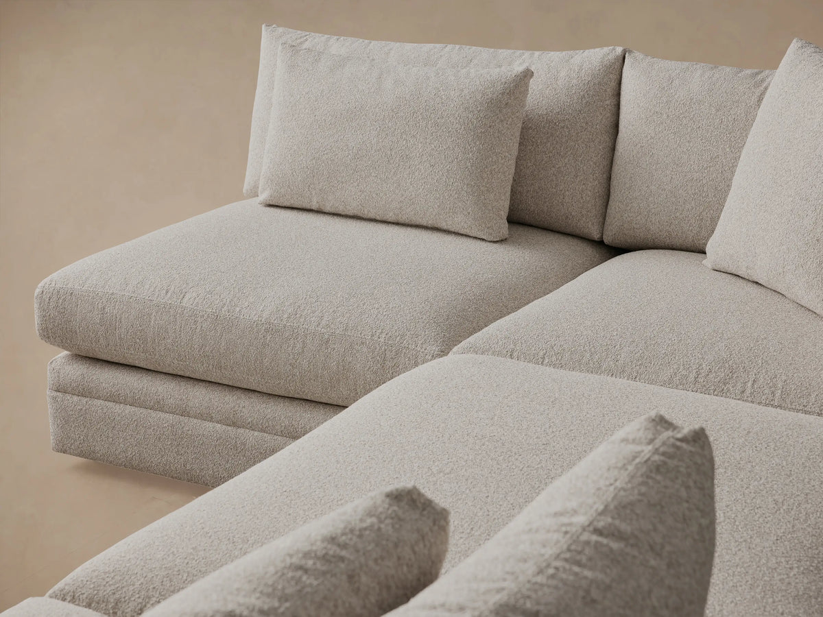 Front view of the light gray Pavo Three-Piece Sectional, featuring an L-shaped configuration with a separate sofa segment.