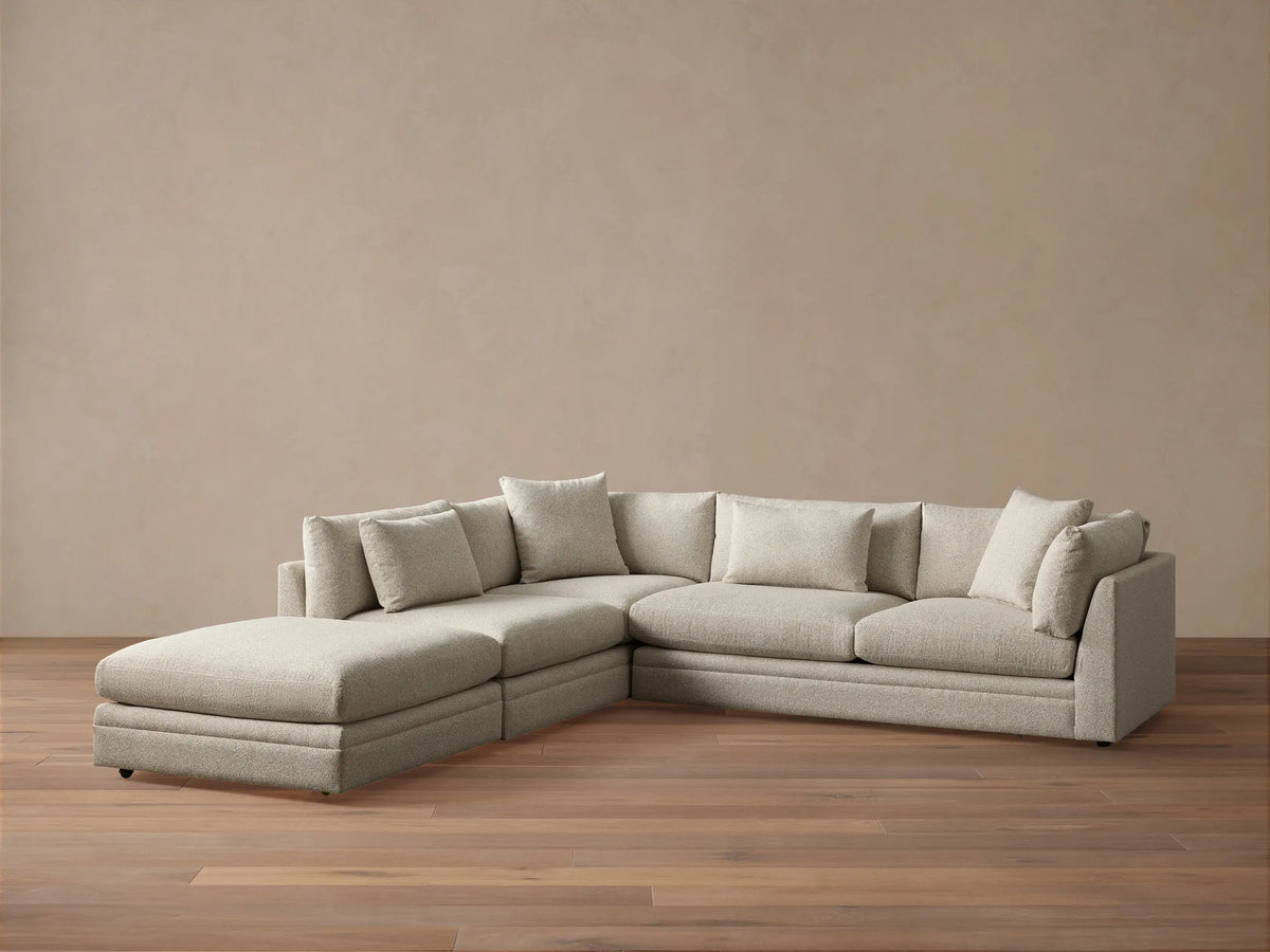 Close-up of a light beige Pavo Three-Piece Sectional, showing textured fabric on seat and back cushions.