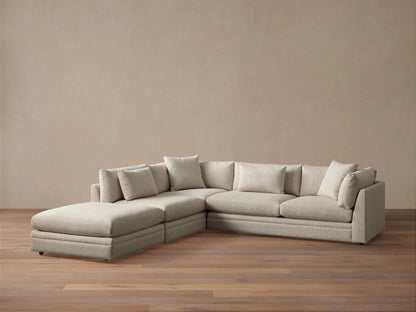 Close-up of a light beige Pavo Three-Piece Sectional, showing textured fabric on seat and back cushions.