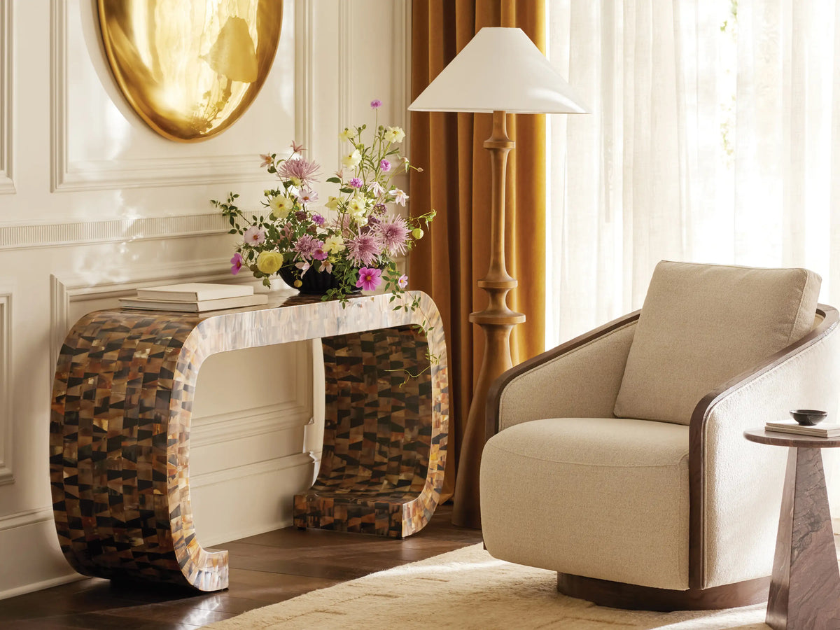 Front view of the beige leaf-patterned Pomona Swivel Chair, with exposed light oak arms and a round swivel base.