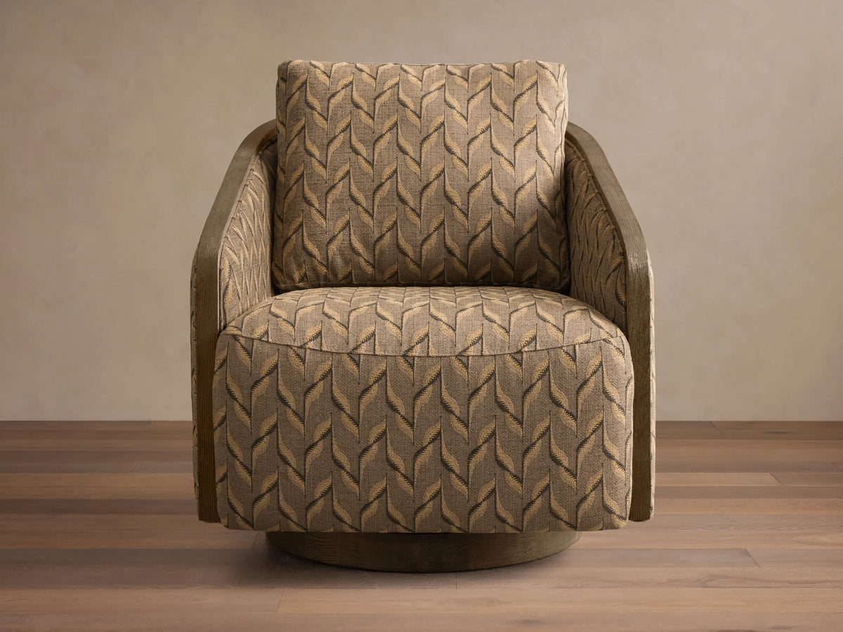 Front-right view of a neutral beige Pomona Swivel Chair with exposed oak arms and swivel base, on a light rug.
