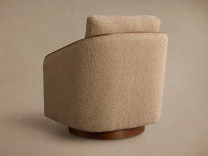 Close-up of the beige Pomona Swivel Chair's Crypton¬Æ Nomad Snow bouclv© fabric and exposed oak armrests.