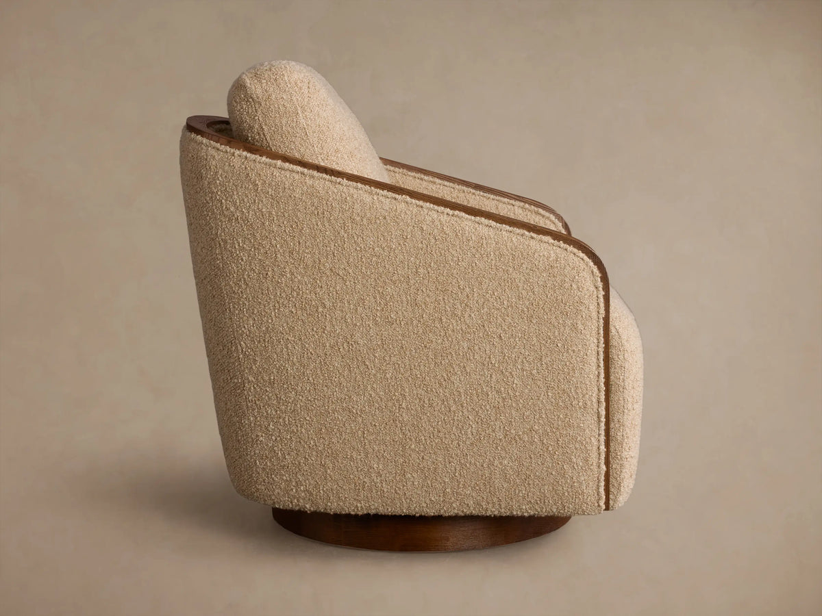 Rear view of the beige textured Pomona Swivel Chair, showing exposed oak edges and dark wood swivel base.