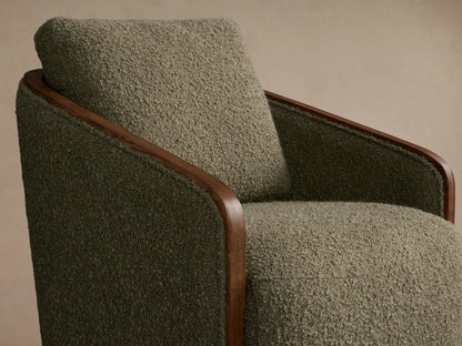 Front view of an olive green bouclv© Pomona Swivel Chair with exposed light brown oak arms and a round wooden swivel base.