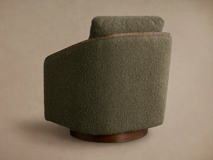 Close-up of the moss green textured fabric and dark oak frame of the Pomona Swivel Chair.