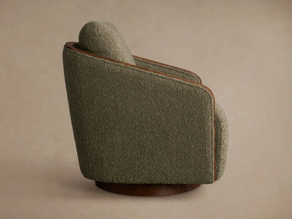 Rear view of the Pomona Swivel Chair, upholstered in olive green textured fabric with exposed oak trim and a wooden swivel base.
