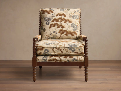 Front view of the beige, brown, and blue patterned upholstery Milly Chair with dark brown spindled wood arms and legs.