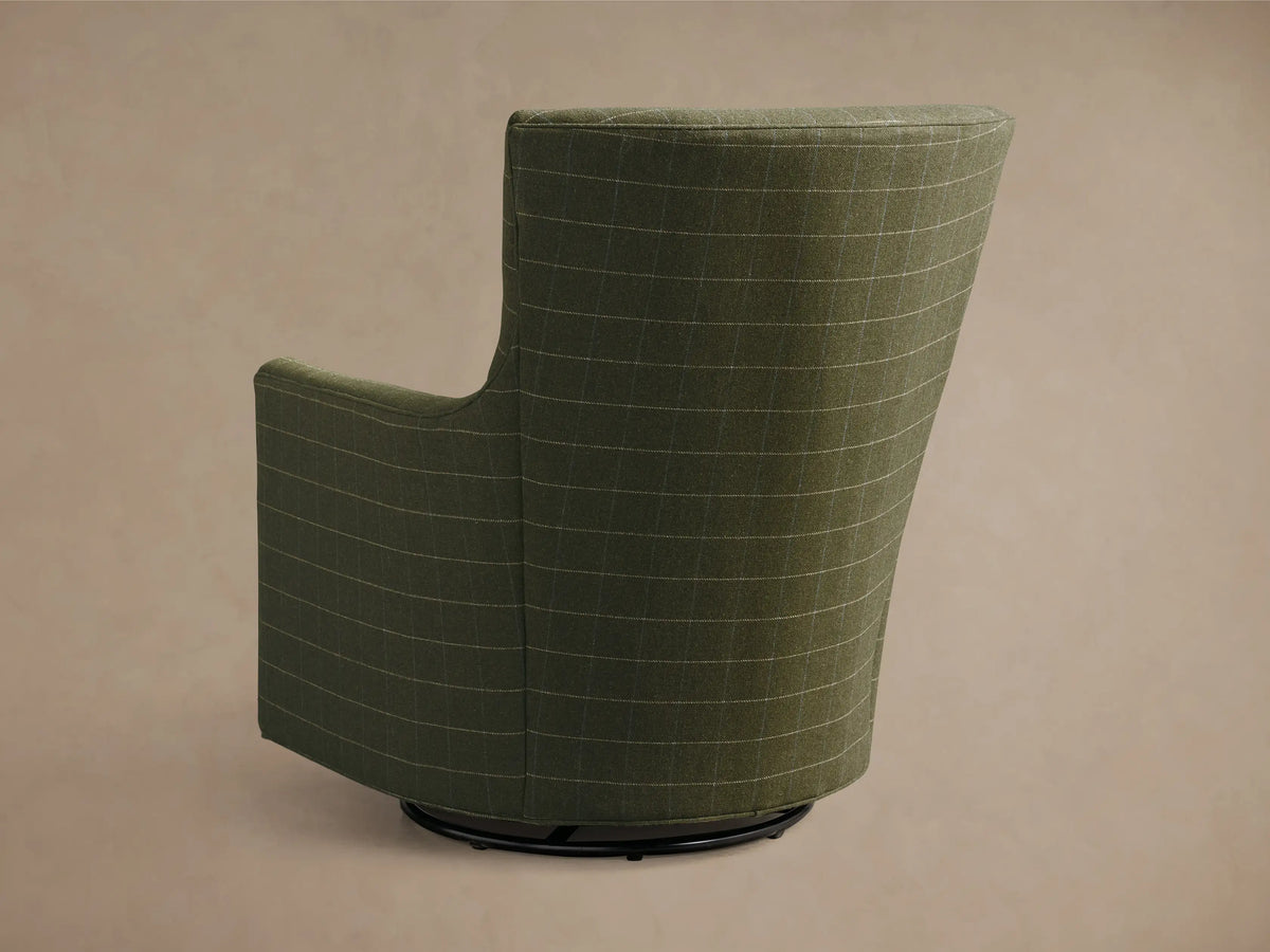 Close-up of the armrest and seat of the olive green plaid Walton Swivel Glider with thin white and blue lines.