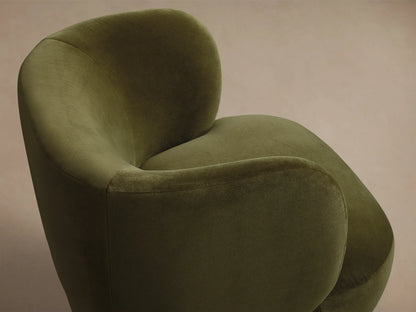 Front view of an olive green velvet upholstered chair with a rounded back and deep seat.