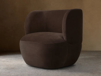 Dark brown Lenny Swivel Chair with plush, rounded backrest and seat, set on a wooden floor. The chair features a seamless, modern design.