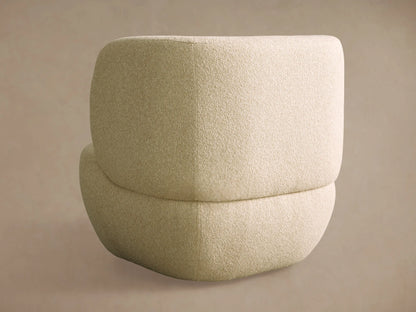 Close-up of Lenny Swivel Chair, showing its creamy, textured fabric on the curved seat and armrest.