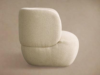Back view of the Lenny Swivel Chair; a plush, rounded, light beige textured chair with a distinctive curved form.