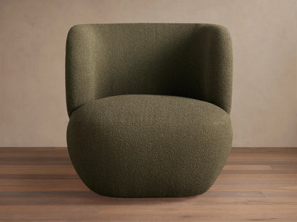 Lenny Swivel Chair: Plump dark green boucle chair with curved back, wide arms, and a solid base, on a wooden floor.