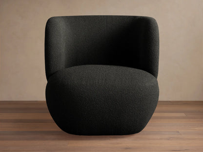 Lenny Swivel Chair: Modern, dark gray/black textured boucle fabric. Curved, armless design, front-right view on a wood floor.