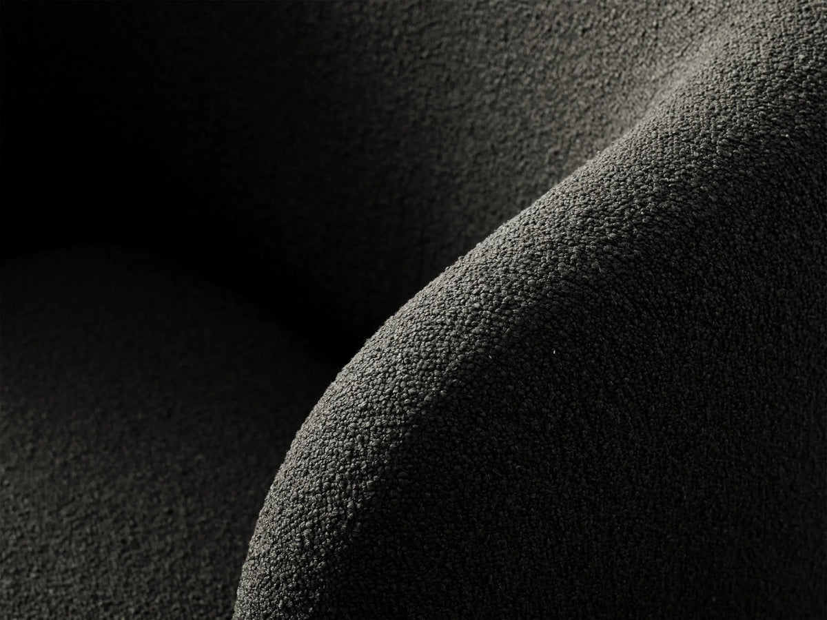 Modern Lenny Swivel Chair in dark gray textured fabric, with a curved back and round base, centered on a wood floor.