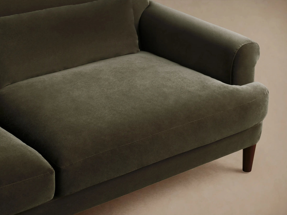 Thorne Sofa: Dark olive velvet sofa with rolled arms, two seat/back cushions, two lumbar pillows, and tapered wood legs.