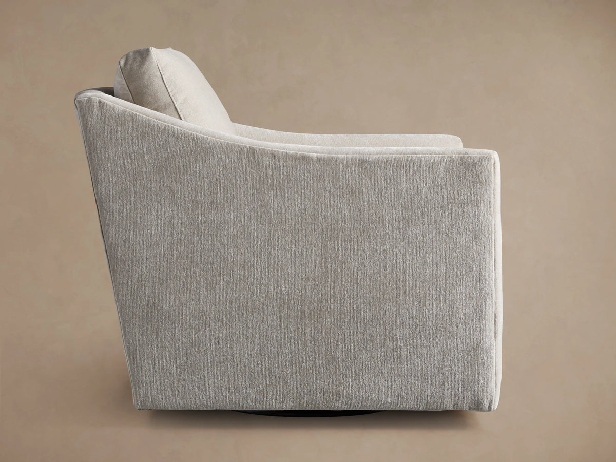 Branson Swivel Chair in a soft beige fabric, showcasing its angled backrest and plush cushion with seamless stitching.