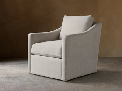 Branson Swivel Chair in beige fabric, features plush seat and back cushions, flared arms, on hardwood floor, against tan background.