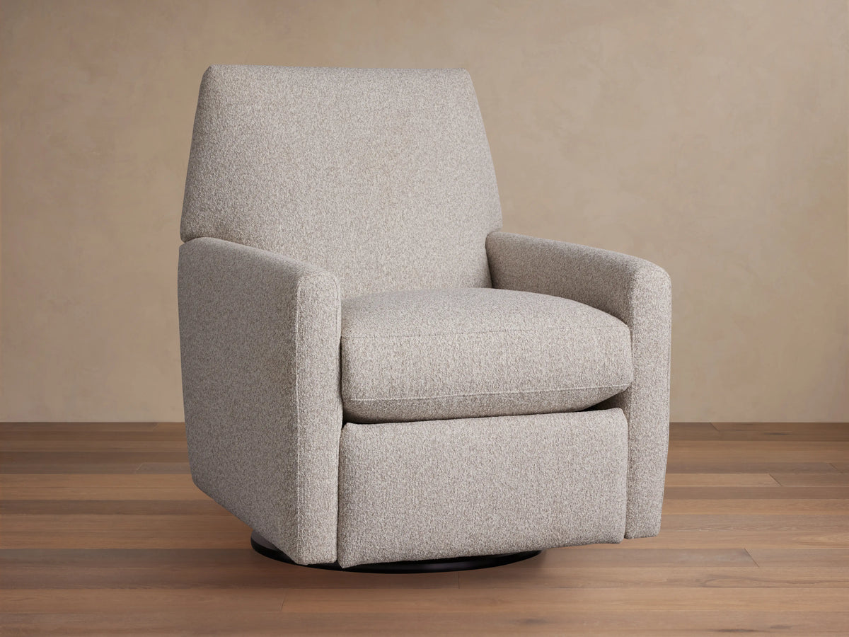 Harvey Swivel Recliner upholstered in light gray textured fabric, upright and facing forward on a wooden floor.