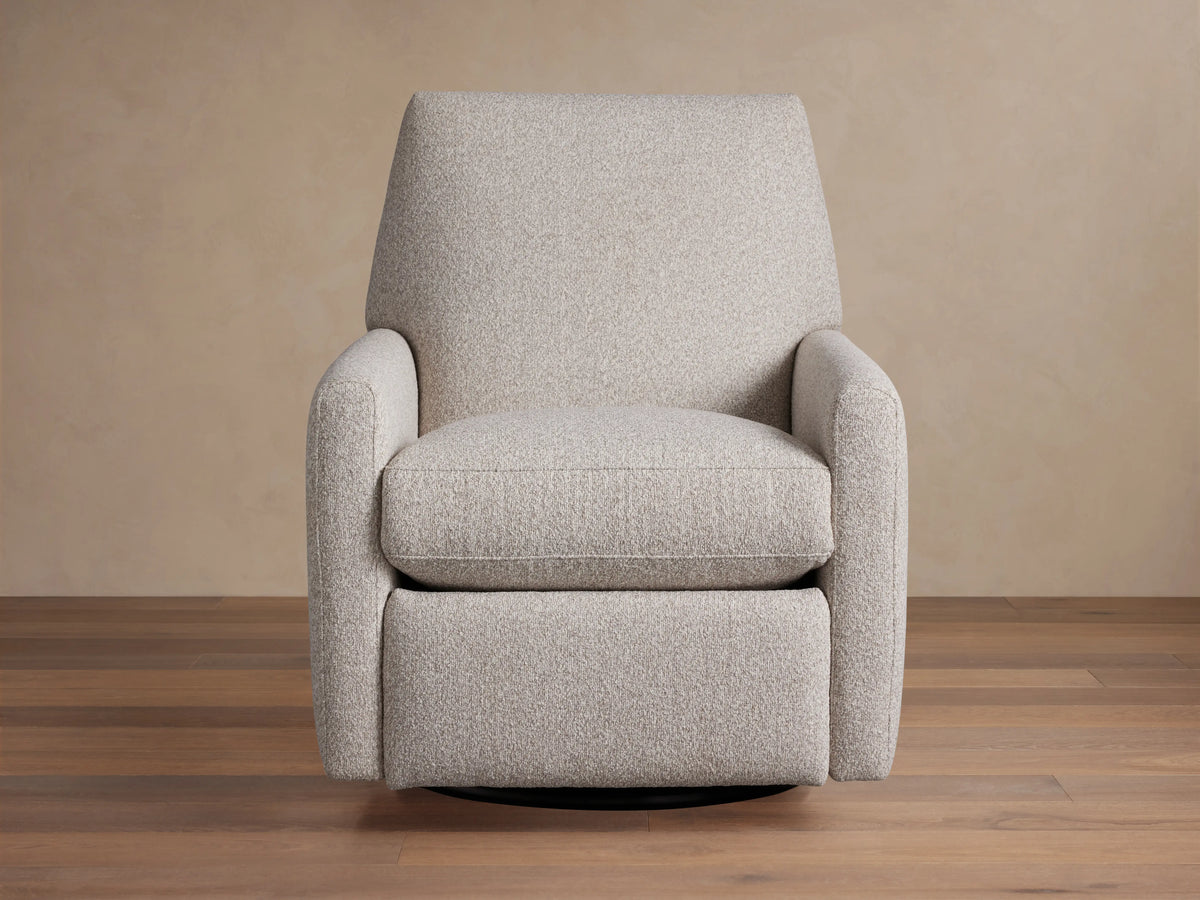 Harvey Swivel Recliner upholstered in light gray textured fabric, upright and facing forward on a wooden floor.