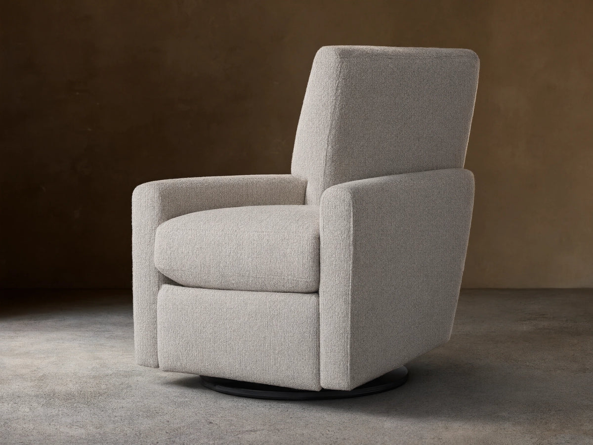 Harvey Swivel Recliner upholstered in light gray textured fabric, upright and facing forward on a wooden floor.