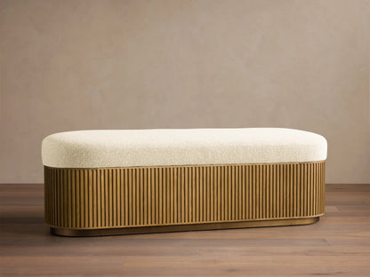 Front view of the Finnley Storage Bench with a cream upholstered top and a honey oak fluted base.