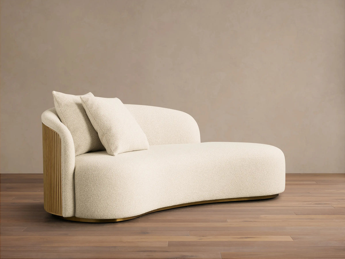Close-up of the cream bouclé upholstery, Honey finished slatted wood armrest of the Finnley Daybed.