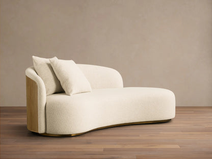 Close-up of the cream bouclé upholstery, Honey finished slatted wood armrest of the Finnley Daybed.