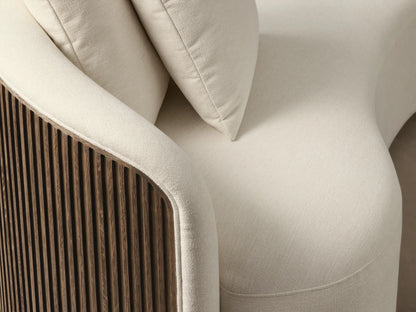 Front view of the cream Finnley Daybed, a curved daybed with a slatted wood side, two matching pillows, and a gold-toned base.