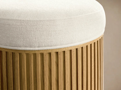 Top-down view of a round Cream Finnley Ottoman with a textured fabric.