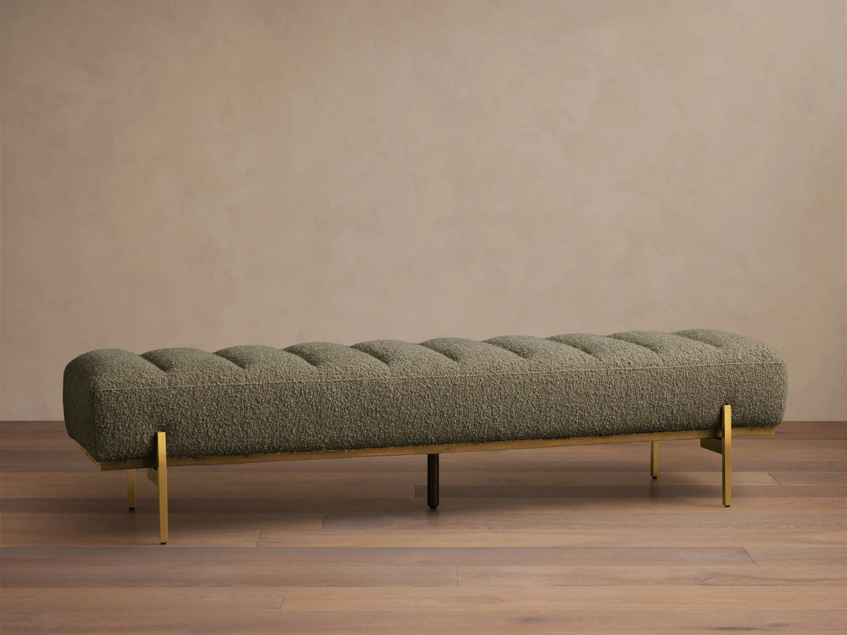 Front view of the olive green Lansing Bench, featuring channel-tufted upholstery and slender gold-colored metal legs.