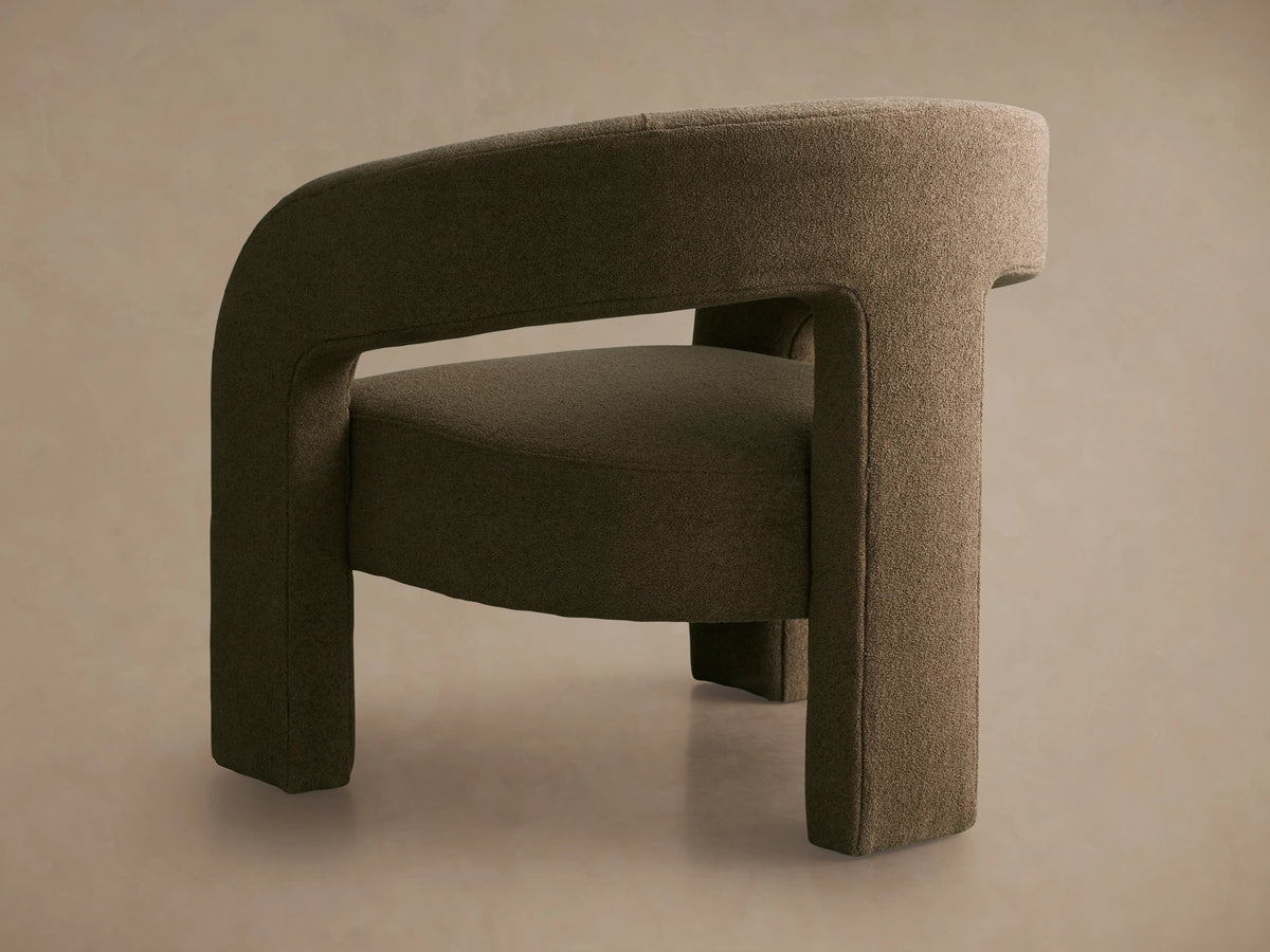 Mara Cutout Chair in taupe fabric, featuring a curved backrest with a cutout design. Shot from above showing texture and back detail.