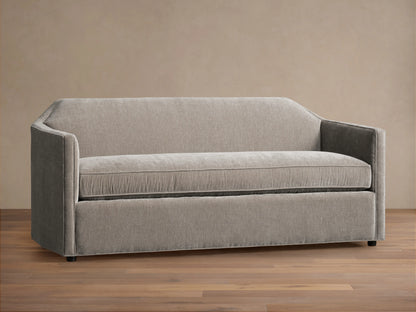 Grey Marina Sofa with a sleek, modern design featuring straight arms and a plush seat cushion. Sits on a hardwood floor with a neutral background.