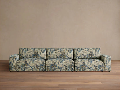 Keegan Three Piece Modular Sofa, upholstered in blue, beige, and brown floral fabric, front view, on a wooden floor.
