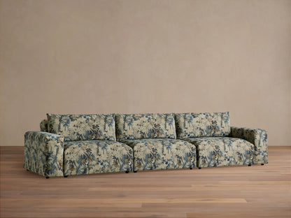 Keegan Three Piece Modular Sofa, upholstered in blue, beige, and brown floral fabric, front view, on a wooden floor.