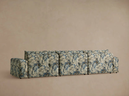 Keegan Three Piece Modular Sofa close-up: blue, green, and beige botanical textured fabric on back and tufted seat cushions.